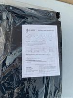 Stadium seat in plastic wrap with instruction sheet on top