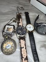 Front view of five watches showing faces and straps