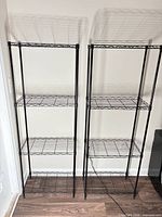Two black wire shelving units side by side