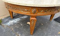 Wood base with carved gilt floral apron and tapered leg