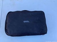 Closed black fabric carry case with onn. logo