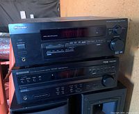 Front view of both Pioneer receivers stacked, showing model labels and controls