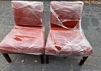 Front view of both rust fabric chairs wrapped in film