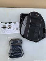 Unpackaged back brace, pad insert and instruction sheet