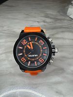 Front view of Unlisted watch showing dial, orange band