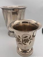 Both silver-tone urn vases, front view