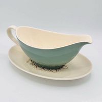 gravy boat on drip plate, side view