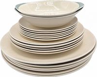 Stack of entire 19-piece set showing plates and blue-exterior bowls