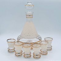 full view of decanter with stopper and six glasses