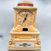 Front view showing clock face, hat, bowtie detail