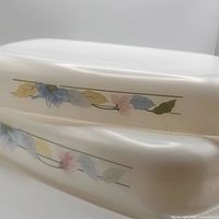 Side view showing stacked dishes and floral band detail