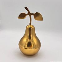 Front view of brass pear trinket dish with lid on
