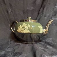 Full side view of Gibsons sage green and silver-luster teapot with ivory relief