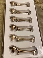 Six silver-plated dachshund rests in box insert