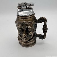 Front view of figural Toby mug lighter showing face detail and lighter mechanism