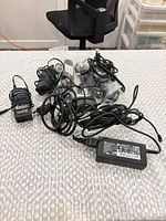 Overview of entire lot with power bricks and loose cables on table