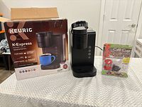 Overall lot view showing brewer, retail box, Café Cup pack