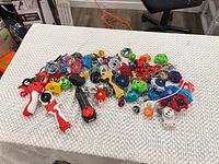 Full lot spread on table showing launchers, tops and parts