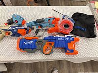All blasters, drum magazine and vest laid out