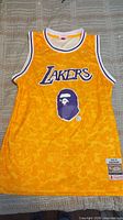 Full front view of gold Lakers jersey with BAPE camo pattern