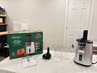 full lot showing juicer, two pitchers, food pusher, manual, box