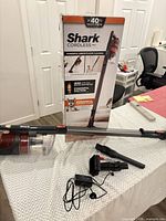 Overall lot with box, vacuum and accessories visible