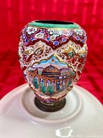 Front view showing enamel floral and architectural painting