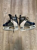 Both skates side view showing holders, blades, and overall wear