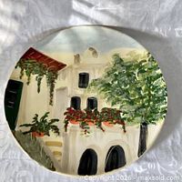 Front view of hand painted ceramic wall plate showing Italian village scene