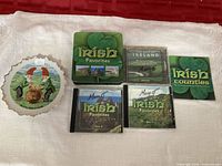 Entire lot showing plate, tin, booklet and three CD cases