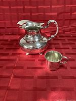 Water pitcher and cup front view, showing overall design and finish