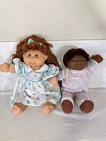 Both dolls standing side by side fully dressed