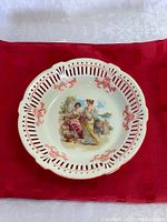 Top view of porcelain bowl with pierced rim and central scene