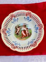 Top view showing entire bowl, rim piercing, colour scheme and central figure scene