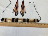 Full view of choker necklace with ruler and both earrings