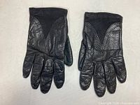 pair of black leather gloves with V-panel detailing