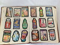 Open binder showing two full pages of die-cut Wacky Cards