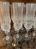 Group of crystal champagne flutes showing cut pattern and stems