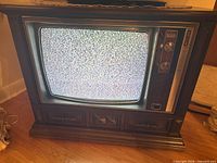 Front view of Zenith Chromacolor console TV powered on displaying static