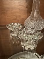 Decanter base and two tea light holders showing cut pattern and clarity