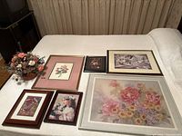Overview of six framed prints and dried flower arrangement