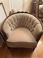 Front view of tufted barrel armchair