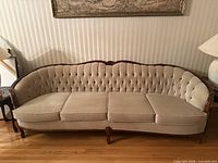Front view of beige tufted sofa