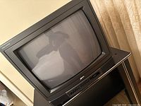 Front view of Zenith CRT television on media stand