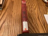 Spine of red hardcover book with library label