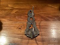 Front view showing ornate cast iron backplate and forward spike