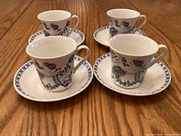 Set of four Figgjo Lotte cups each on individual saucers