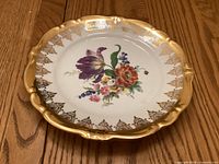 Front view showing floral decoration and gold rim