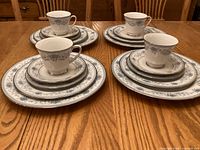 Stacked place settings showing plates, cups, saucers