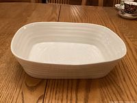 Side view of white textured oval baking dish